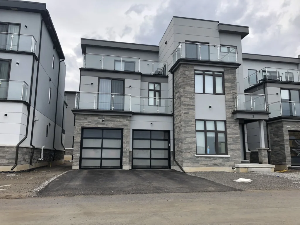 Modern grey custom home in stucco and stone veneer
